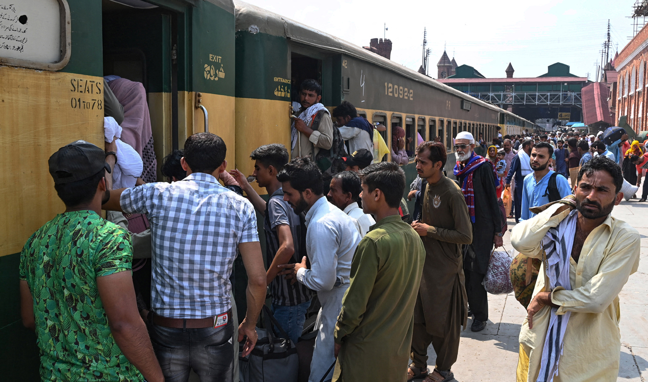 People board a train at a railway station as they return home ahead of the Muslim festival Eid Al-Adha in Lahore on June 27, 2023. (AFP/File)