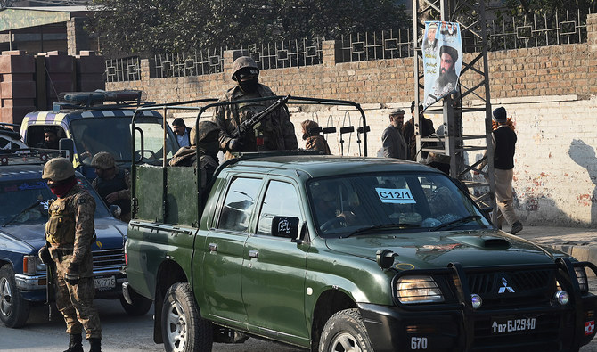 Pakistan Army personnel patrol stand guard on a street in Peshawar on February 7, 2024, (AFP/File)