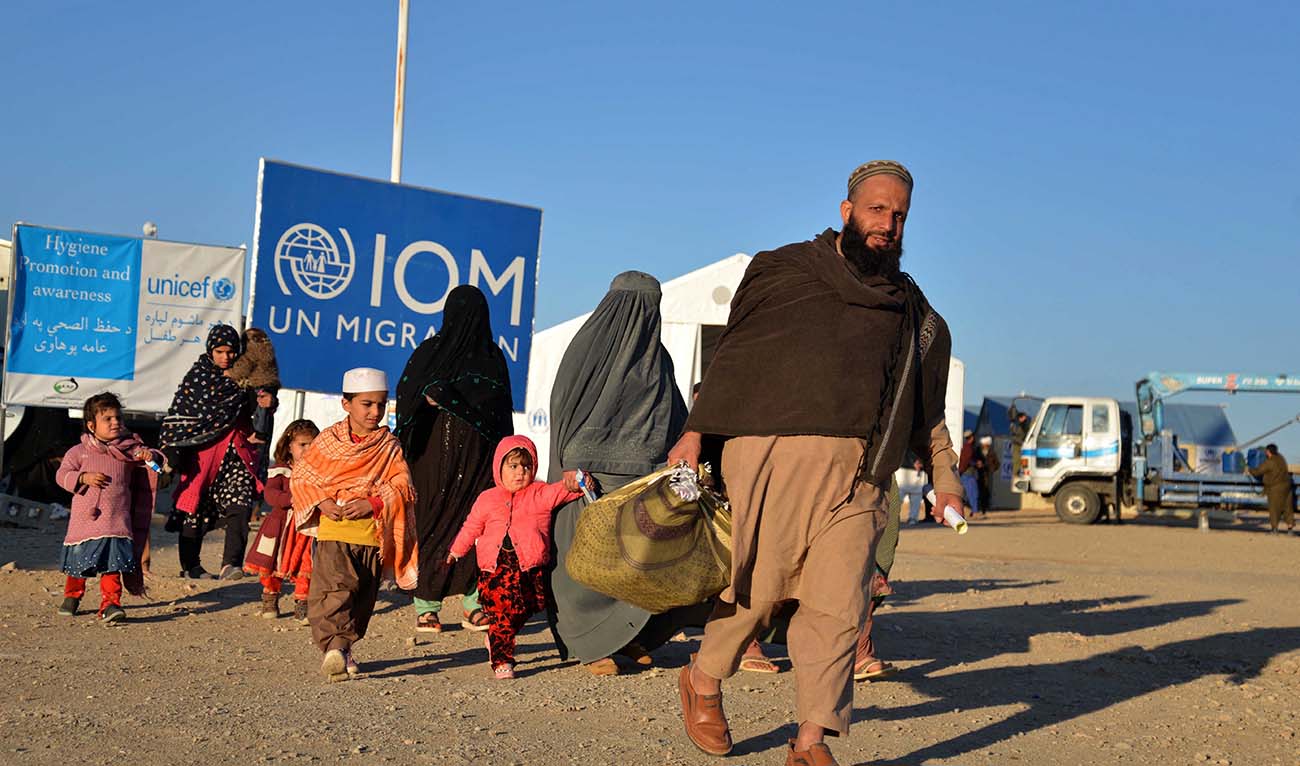 Afghan refugees walk at a registration centre, upon their arrival from Pakistan in Takhta Pul district of Kandahar province on December 18, 2023. (AFP/File)