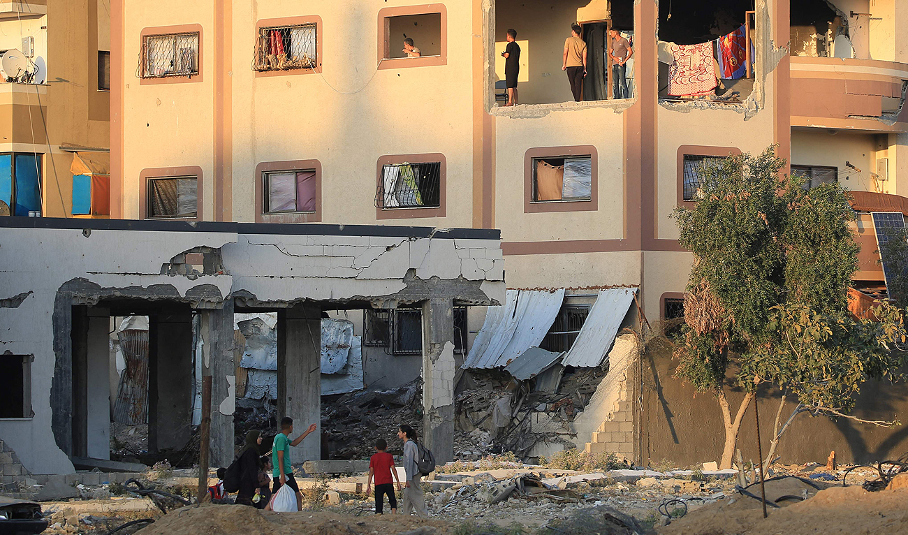 Displaced Palestinians gather in a damaged building used as a temporary shelter in Al-Bureij refugee camp in the central Gaza Strip on June 12, 2024, amid the ongoing conflict between Israel and the Hamas. (AFP)