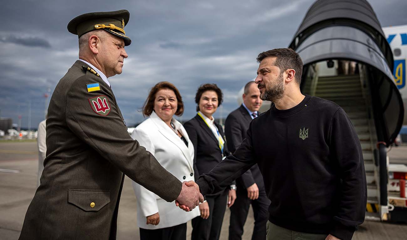 Ukraine's President Volodymyr Zelensky (R) is welcomed by a Ukranian military personnel and Ukraine's Ambassador to Switzerland Iryna Wenediktowa (C) as he arrives at the Zurich airport on June 14, 2024, ahead of the Ukraine Peace Summit in Switzerland. (AFP/File)