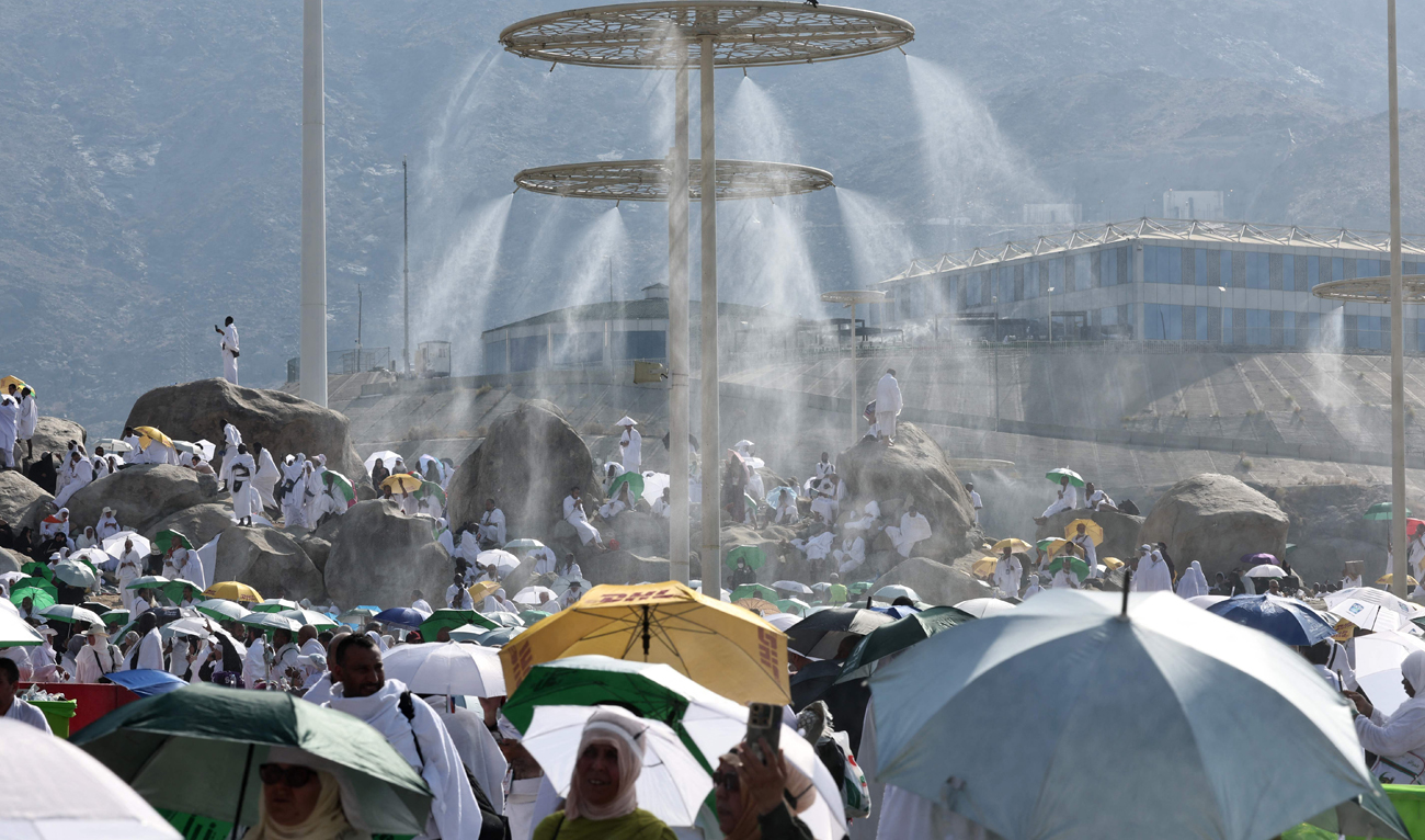 Mist dispensers refreshen Muslim pilgrims at the base of Saudi Arabia’s Mount Arafat, also known as Mount of Mercy, during the climax of the Hajj pilgrimage on June 15, 2024. (AFP)
