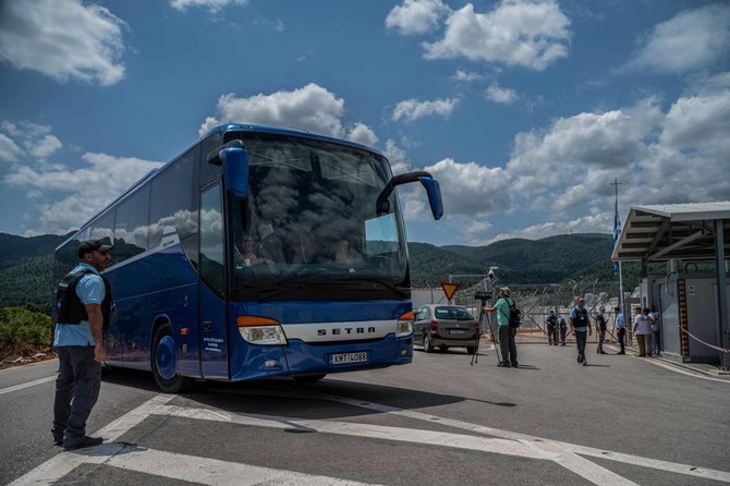 In this file photo, a bus with survivors of a shipwreck enters a migrant camp in Malakasa, near Athens on June 16, 2023, after a boat carrying dozens of migrants sank in international waters in the Ionian Sea. (AFP/File)