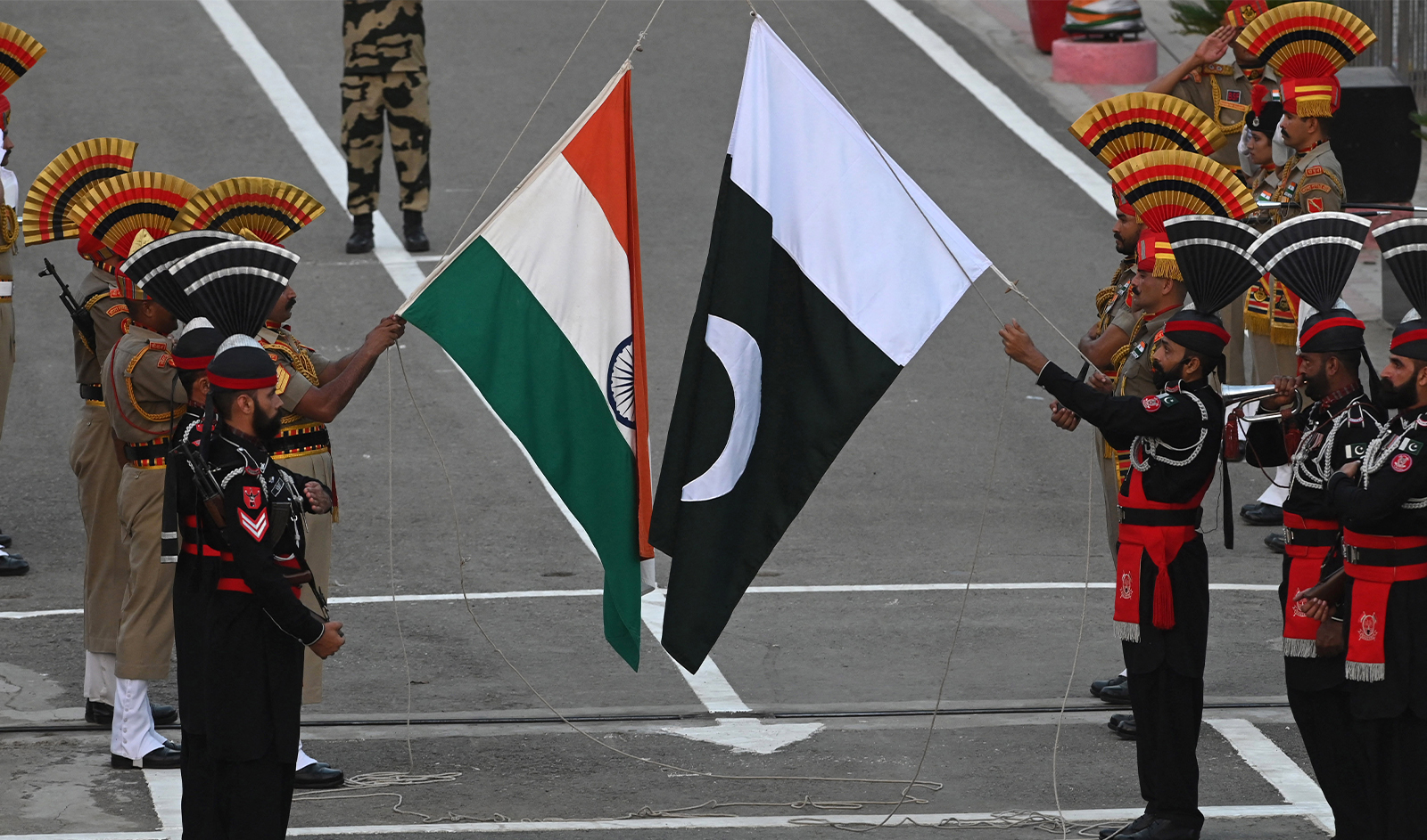 Pakistani Rangers (in black) and Indian Border Security Force (BSF) soldiers take part in 'Beating the Retreat' ceremony on the eve of Pakistan's Independence Day celebrations at the Pakistan-India Wagah border post, about 35km from Lahore on August 13, 2023. (AFP/File)