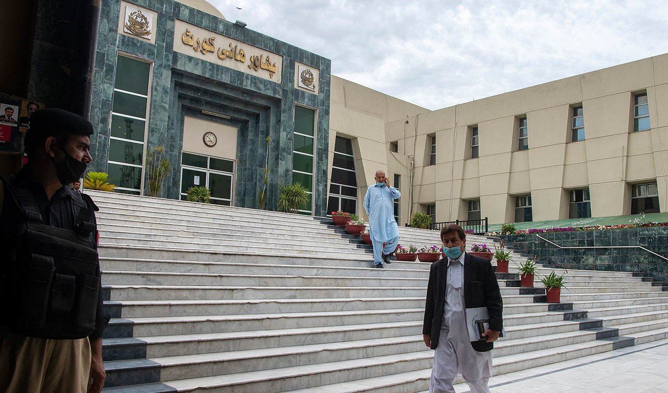 In this file photo, taken on April 20, 2021, a lawyer walks past the High Court building in Peshawar. (AFP/File)