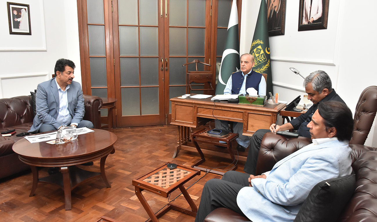 In this handout photograph, taken and released by Prime Minister Office, Pakistan Prime Minister Shehbaz Sharif chairs a meeting regarding law and order and security projects in Islamabad with Interior Minister Mohsin Naqvi (2R) in Lahore on June 23, 2024. (Photo courtesy: PMO)