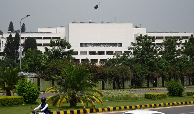 Commuters drive past the parliament house building in Islamabad, Pakistan, on August 9, 2023. (AFP/File)