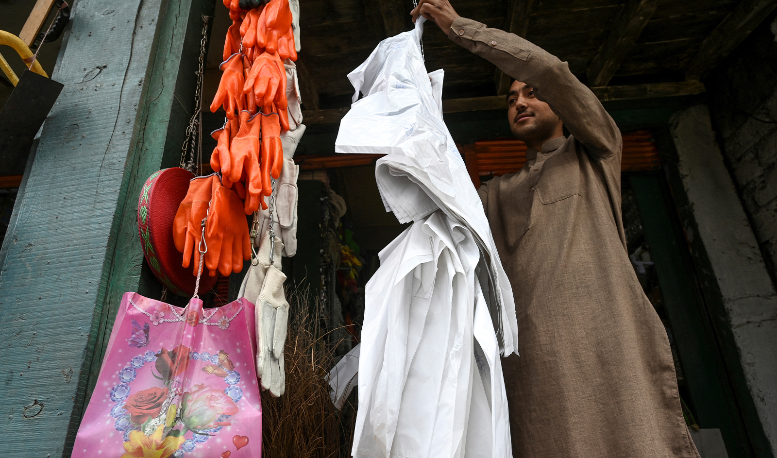 In this picture taken on May 17, 2019, a vendor hangs biodegradable bags for sale at a market in Chitral. (AFP/File)