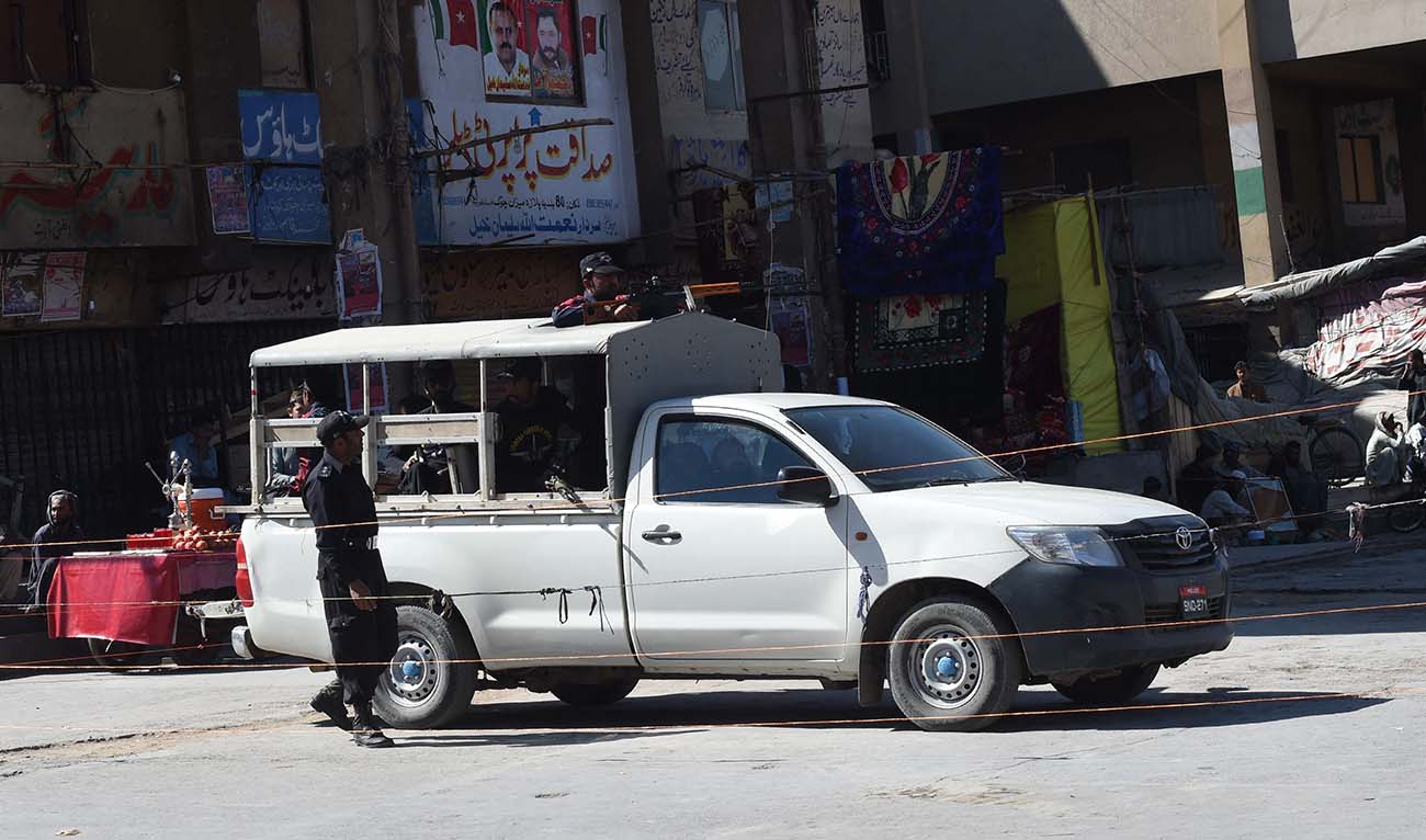 Pakistani policemen stand guard in front of shuttered shops at the market during a strike in Quetta on October 26, 2016. (AFP/File)