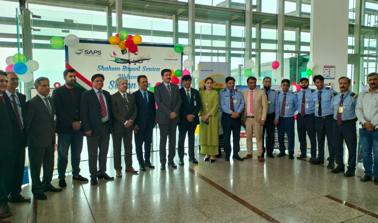 In this handout photograph, taken and released by Pakistan’s Civil Aviation Authority, Governor Khyber Pakhtunkhwa Faisal Karim Kundi (8R) and Ambassador of Tajikistan to Pakistan Yusuf Sharifzoda (7R) gesture for a group photo with airport officials after first-ever flight of Somon Air, Tajikistan’s national airline, landed at the Islamabad International Airport in Islamabad on June 27, 2024. (Photo courtesy: CAA)