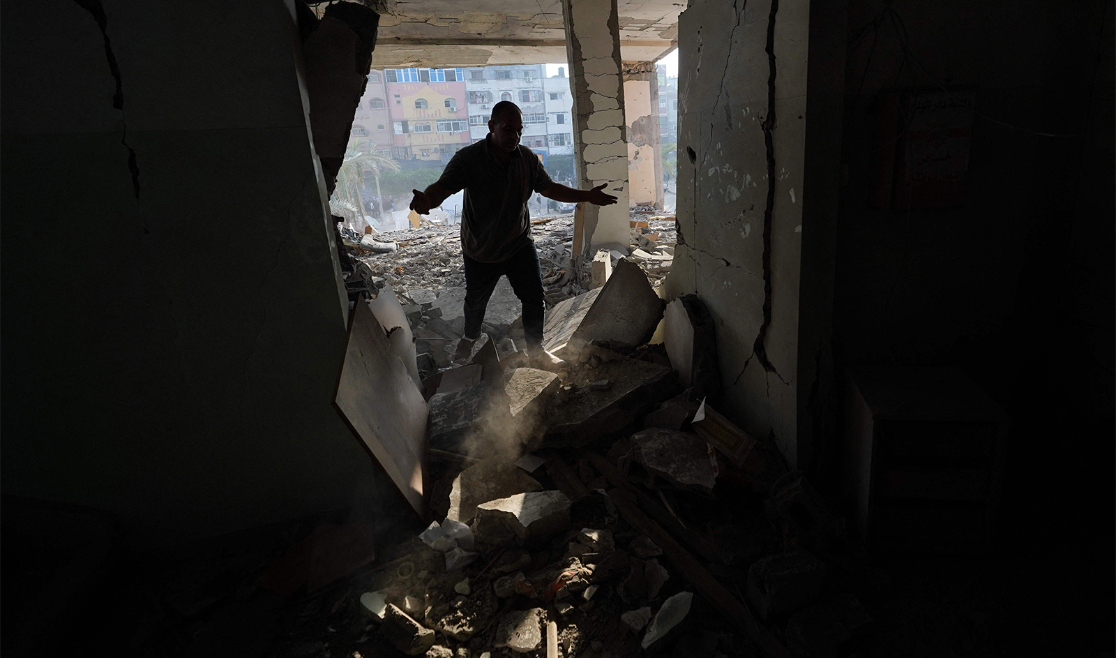 A Palestinian man surveys the damage to the Deir al-Balah municipality building, destroyed following Israeli bombardment of Deir al-Balah, in the central Gaza Strip on June 28, 2024. (AFP)