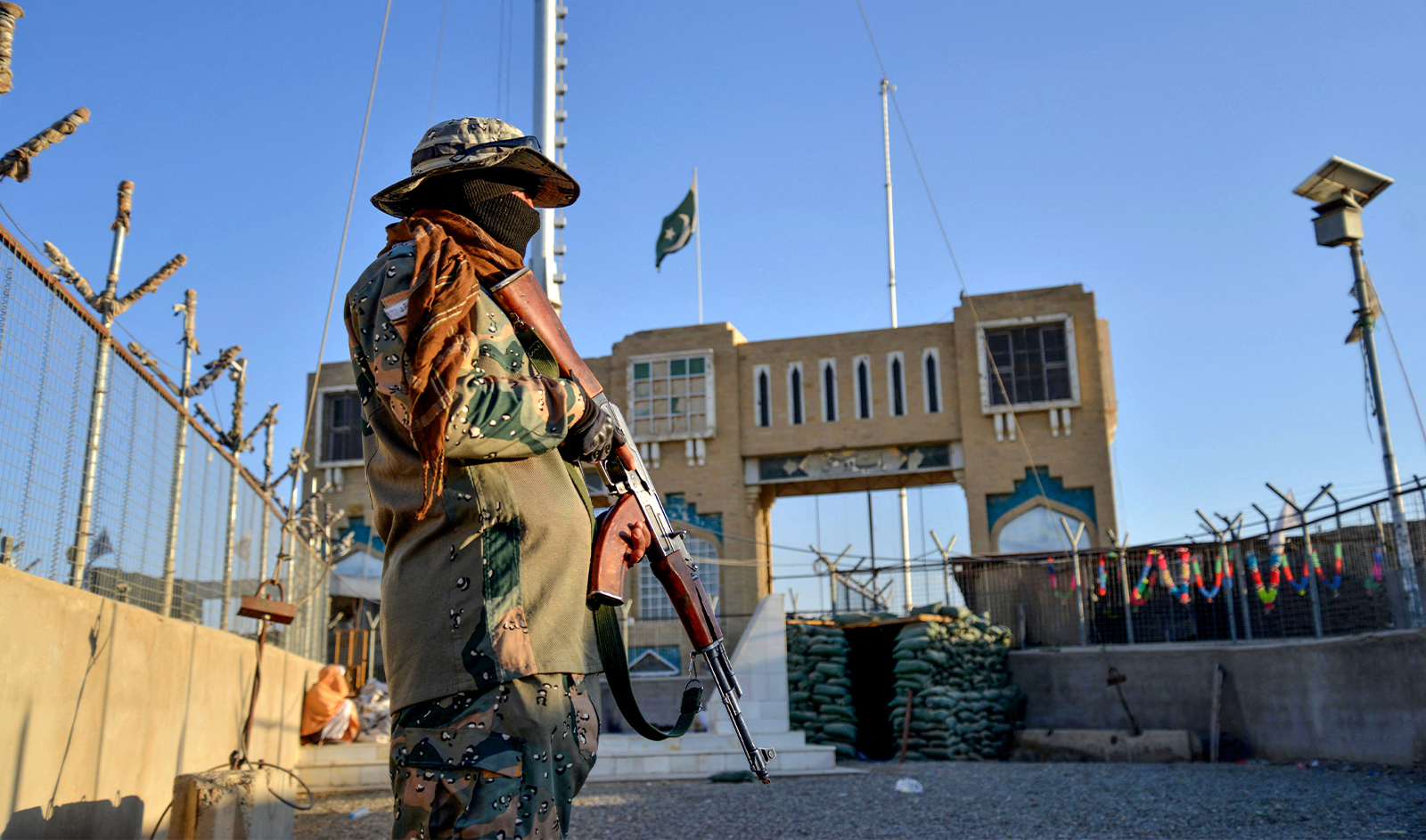 An Afghan security personnel stands guard at a fenced corridor of the Afghanistan-Pakistan border in Spin Boldak district, Kandahar province on December 3, 2023. (AFP/File)
