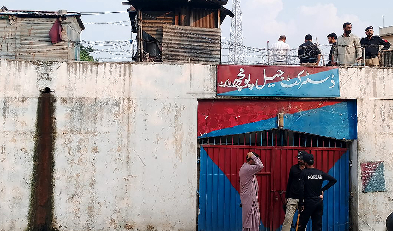 Azad Kashmir policemen investigate after the detainees' prison break in Poonch district jail in Rawalakot city, about 110 kilometres (68 miles) south of Muzaffarabad, the capital of Pakistan-administered Kashmir, on June 30, 2024. (AFP)