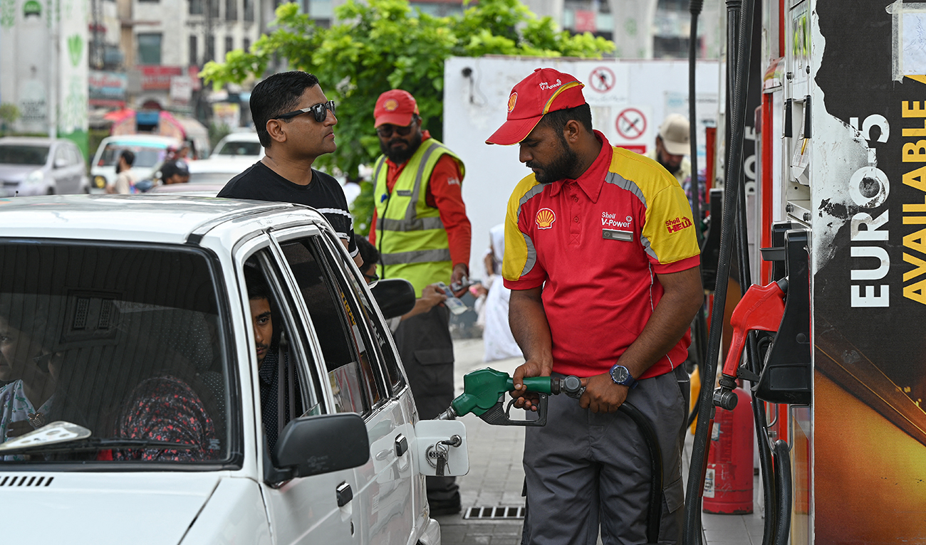 A worker pumps petrol in a car at a fuel station in Rawalpindi on July 16, 2023. (AFP/File)
