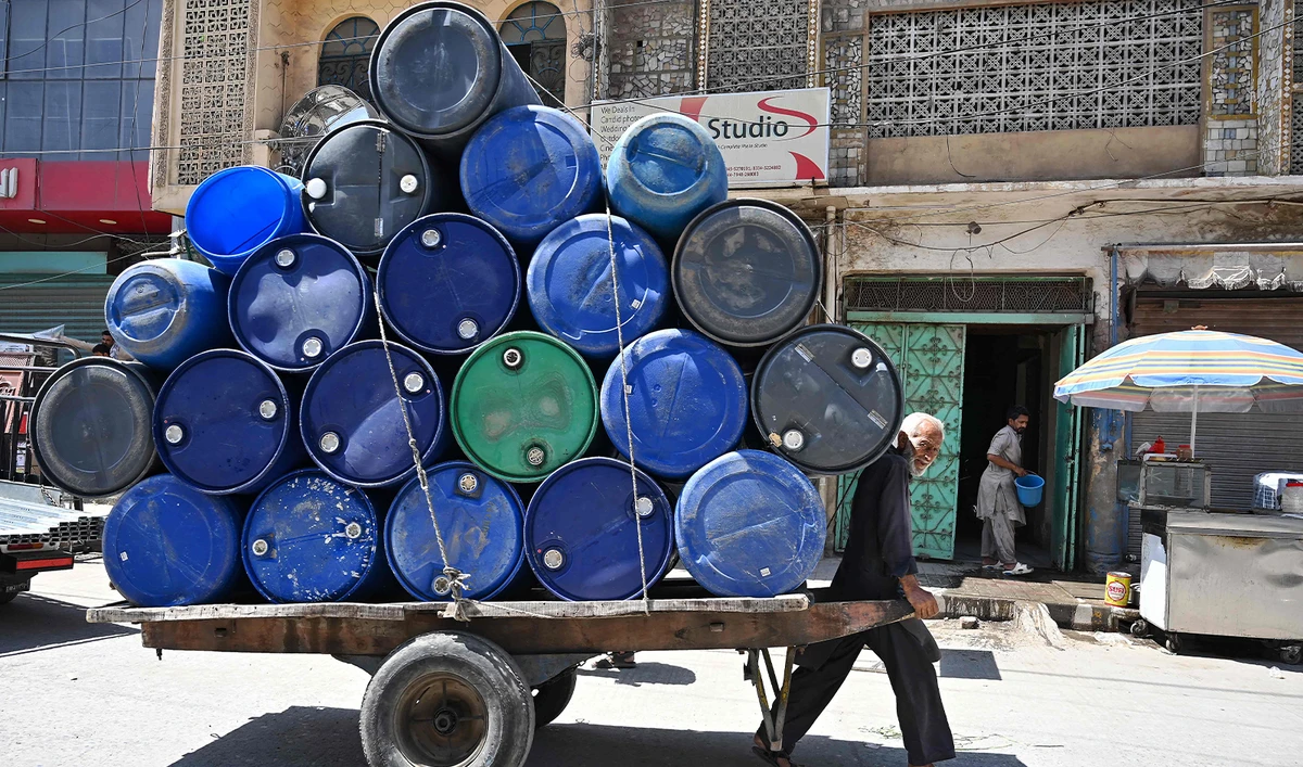 A labourer pulls his handcart along a street on a hot summer afternoon in Rawalpindi on May 30, 2024 amid the ongoing heatwave. (AFP)