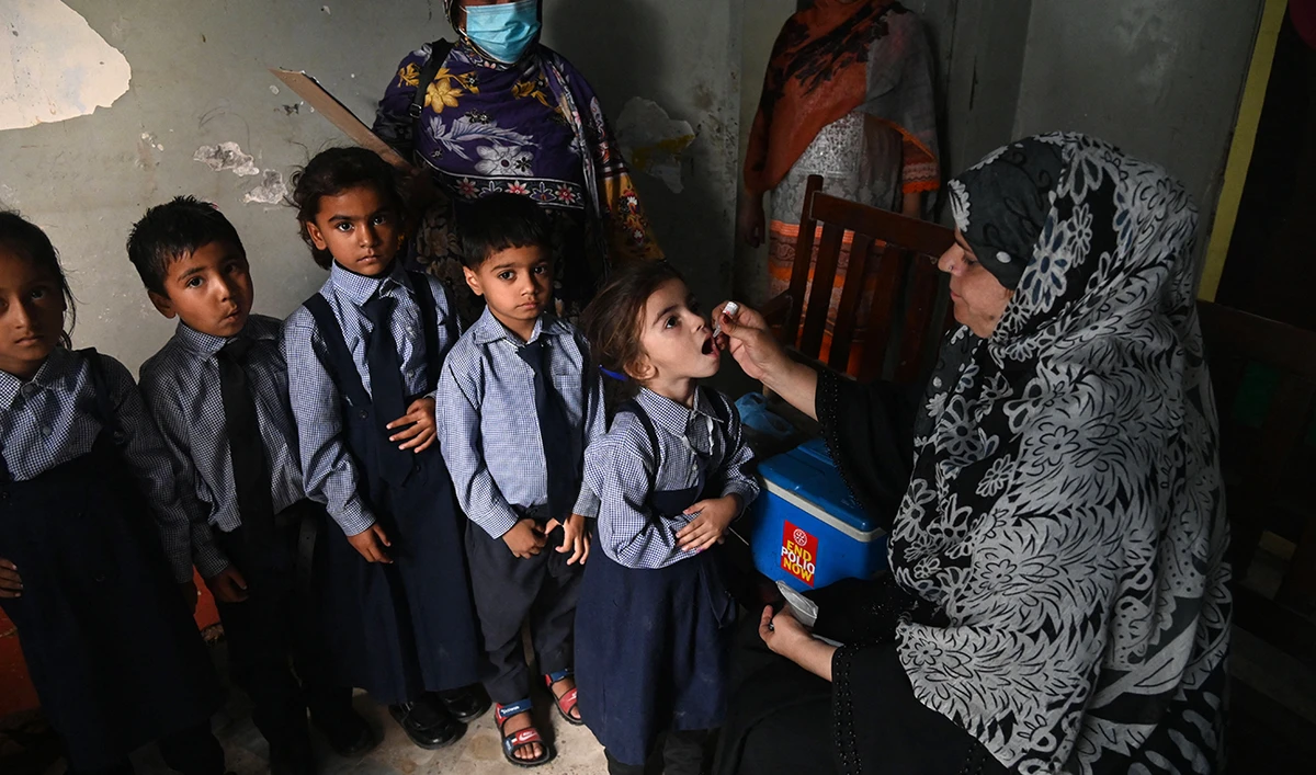 A health worker administers polio vaccine drops to a child during a vaccination campaign in Lahore on October 24, 2022. (AFP/File)