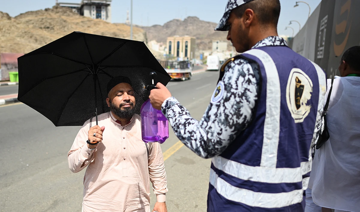 A member of the Saudi security forces sprays water on Muslim pilgrims during the hajj pilgrimage in Mina, near Saudi Arabia's holy city of Mecca on June 29, 2023. (AFP/File)