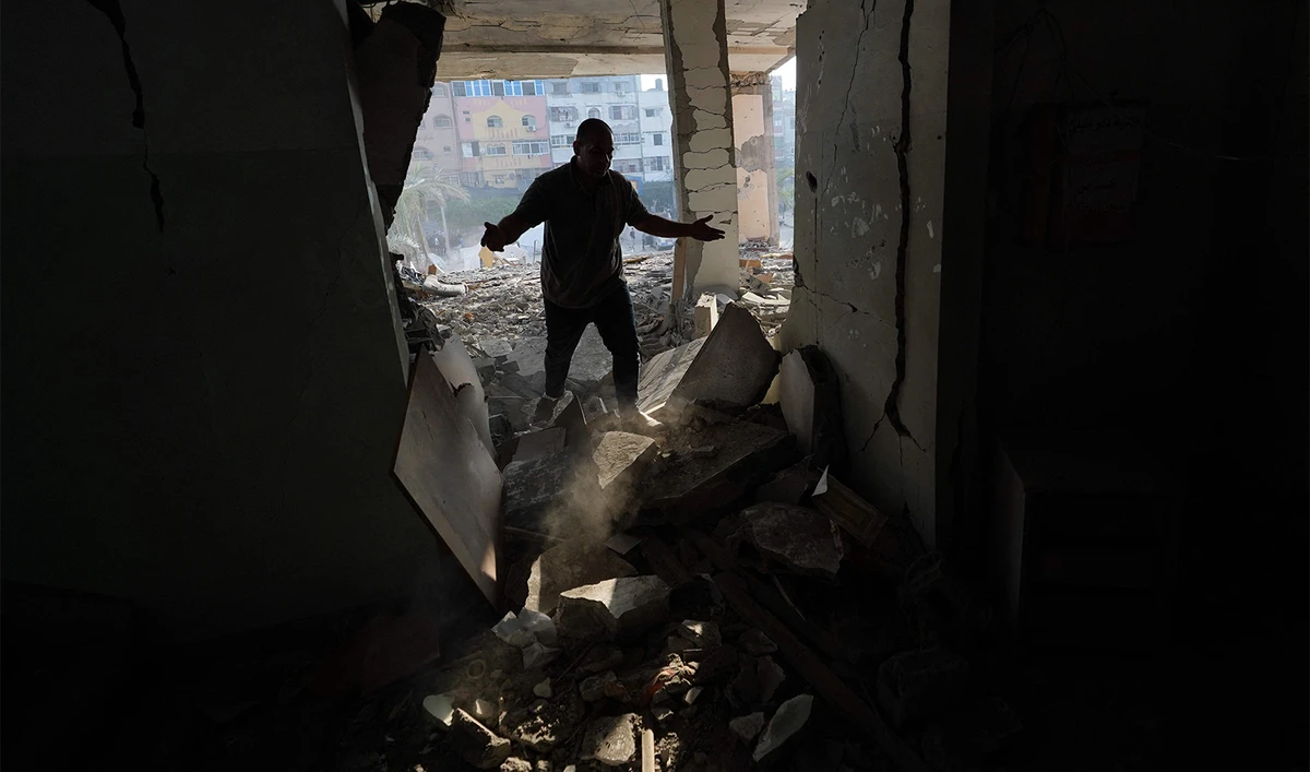 A Palestinian man surveys the damage to the Deir al-Balah municipality building, destroyed following Israeli bombardment of Deir al-Balah, in the central Gaza Strip on June 28, 2024. (AFP)