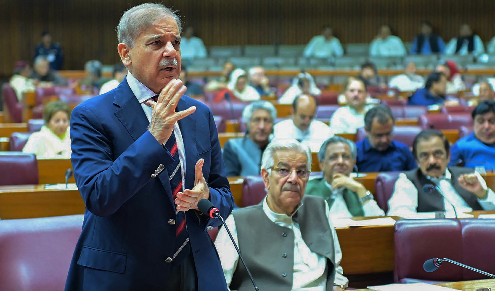 This handout photograph taken and released on June 28, 2024 by Pakistan's Press Information Department (PID) shows Pakistan's Prime Minister Shehbaz Sharif (L) speaking during the budget session at the National Assembly in Islamabad. (AFP/File)