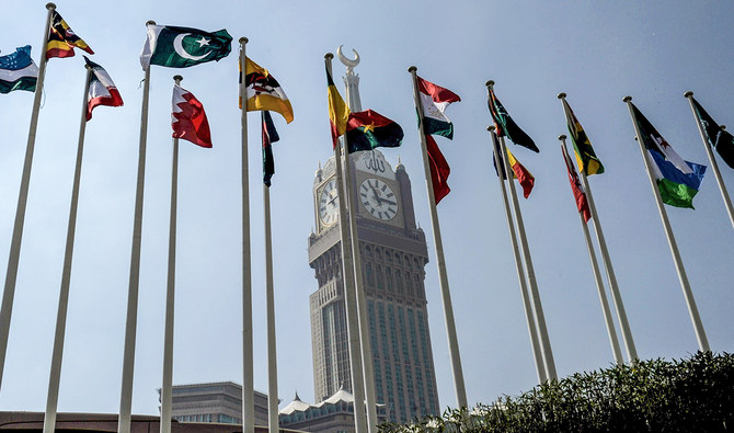A picture taken on November 17, 2016 shows the national flags of the members of Organisation of Islamic Cooperation (OIC) states flying in front of the clock of the Abraj al-Bait Towers which overlooks the Grand Mosque in the holy city of Makkah. (AFP/File)