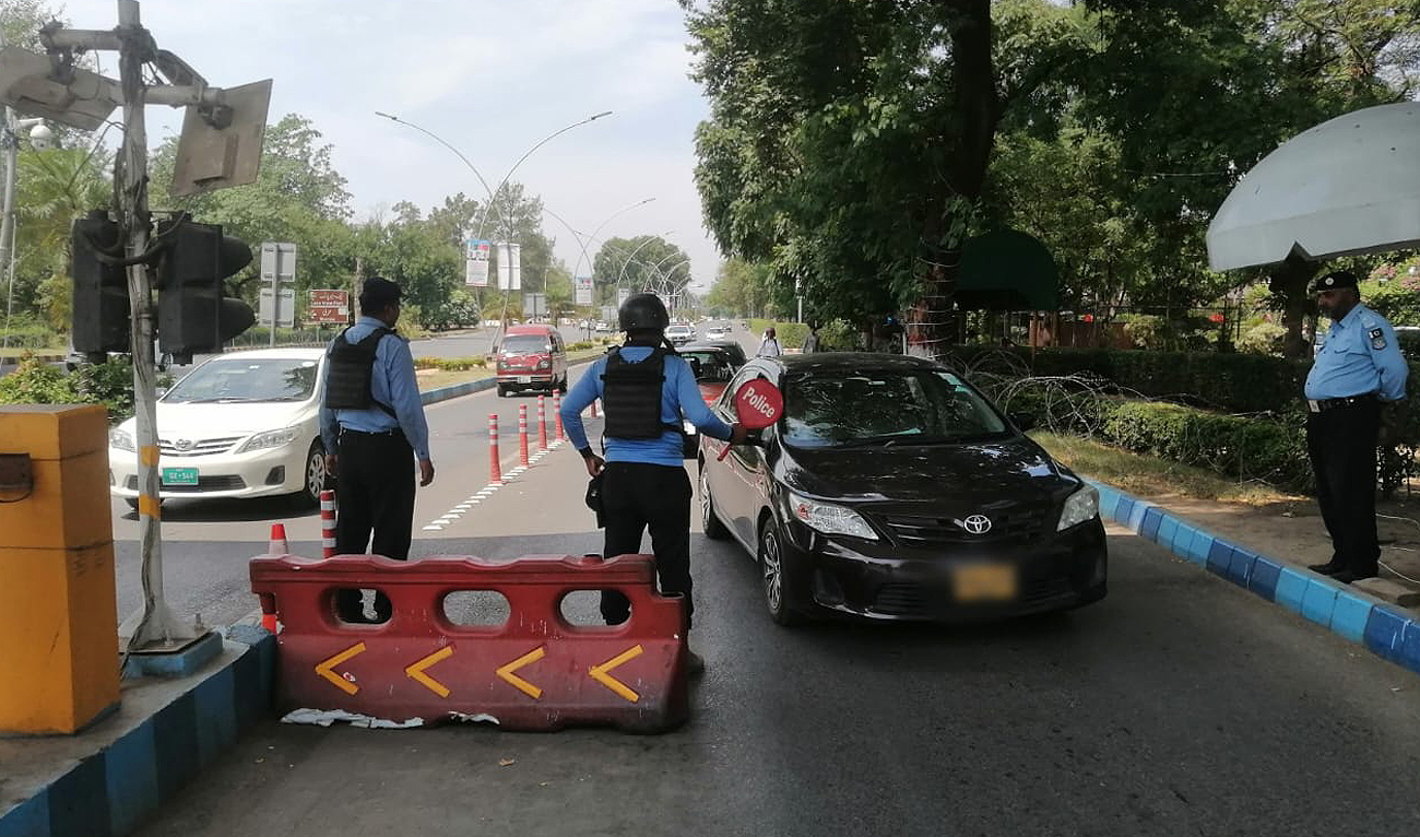 In this file photograph, taken and released by the Islamabad Police on June 21, 2024, security officials check vehicles entering the Red Zone of Pakistan’s federal capital. (Photo courtesy: Islamabad Police)
