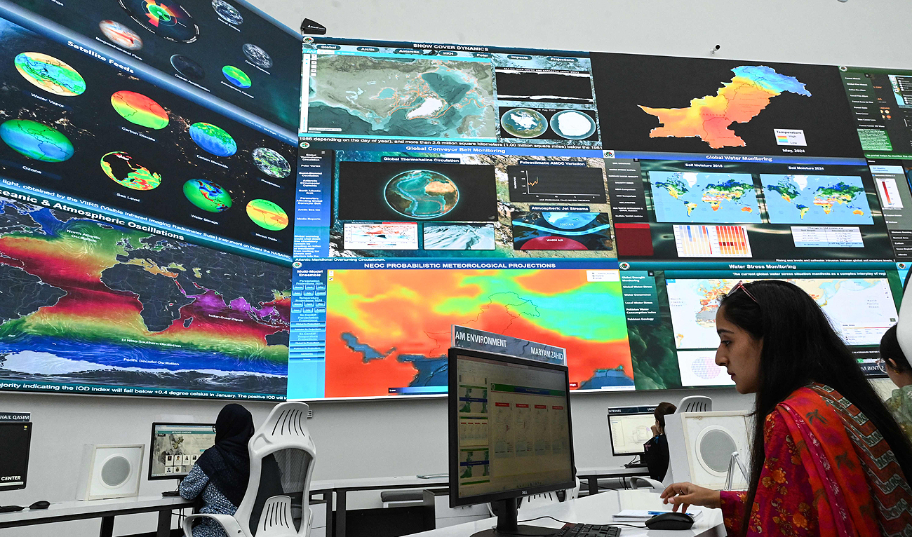 Pakistan’s National Disaster Management Authority (NDMA) staff monitor heat weather conditions at their office in Islamabad on May 23, 2024. (AFP)