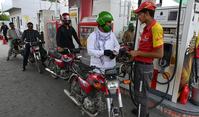 A worker pumps petrol in a motorbike at a fuel station in Rawalpindi on July 16, 2023. (AFP/File)