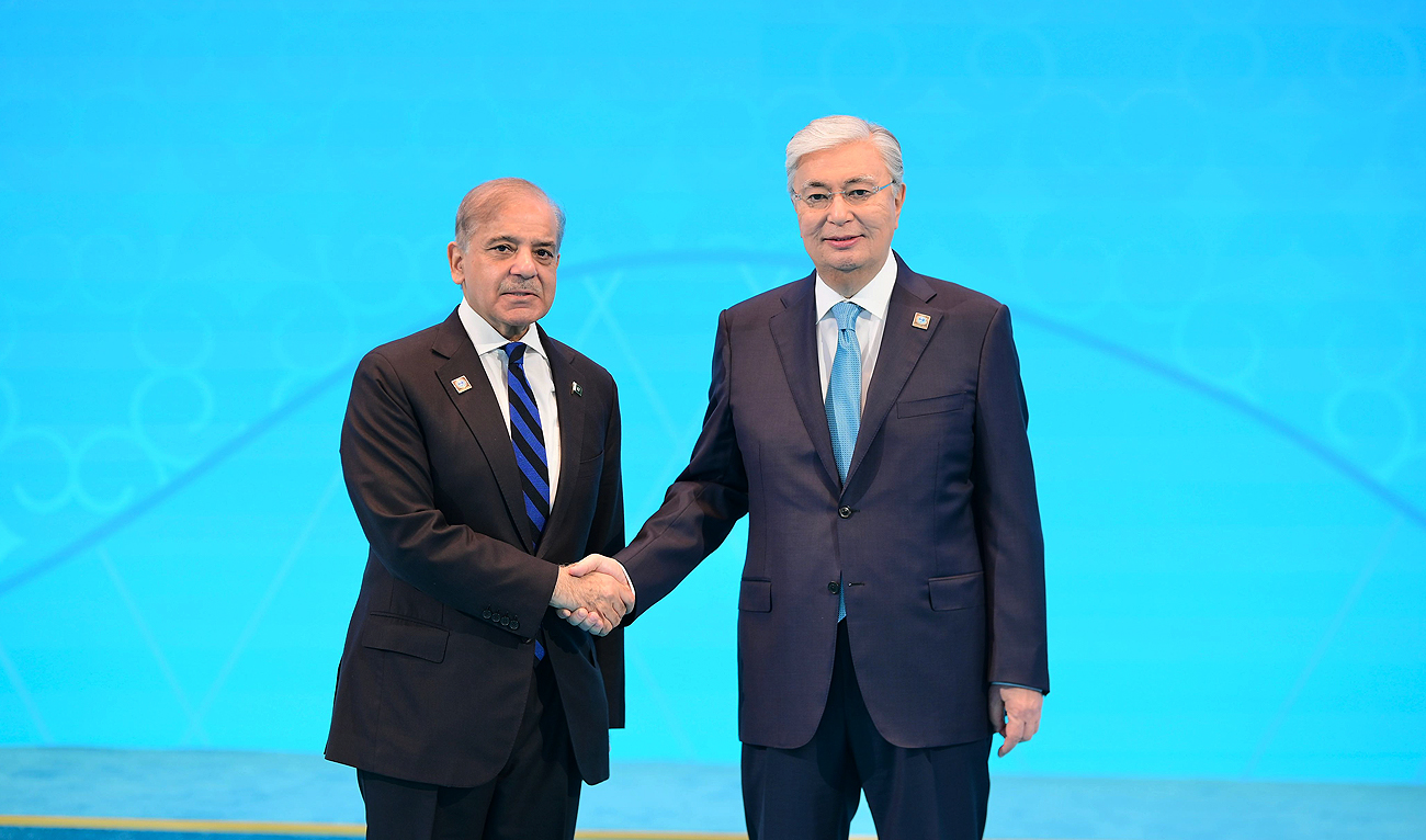 In this handout photograph, released by Prime Minister’s Office, Pakistan Prime Minister Shehbaz Sharif (left) shakes hands with Kazakhstan President Kassym-Jomart Tokayev as he arrives at the Independence Palace of Astana to attend Shanghai Cooperation Organization Summit in Astana on July 4, 2024. (Photo courtesy: PMO)