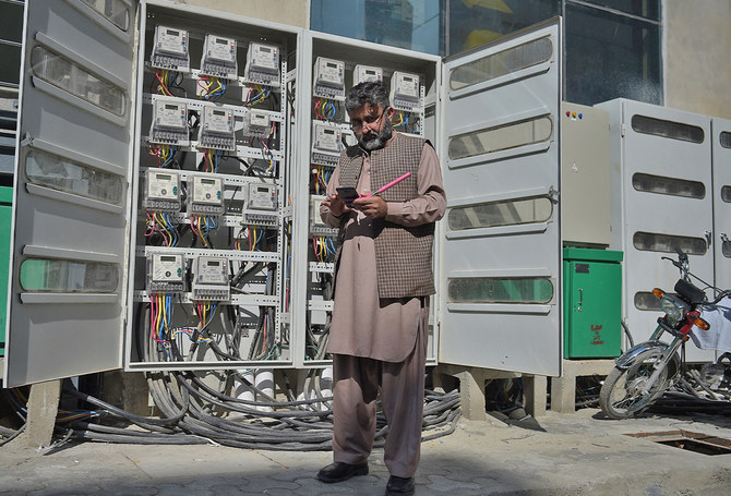 A Pakistani employee of the state-run Islamabad Electric Supply Company (IESCO), takes a meter reading with his smartphone at a commercial building in Islamabad, Pakistan, on November 7, 2018.(AFP/File)