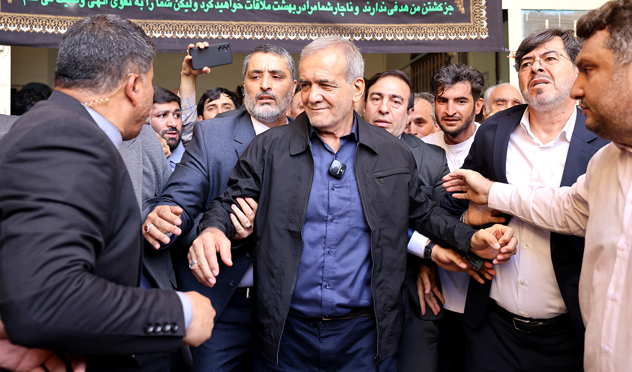 Iranian president Masoud Pezeshkian (C) leaves a polling station after voting in Tehran on July 5, 2024. (AFP)