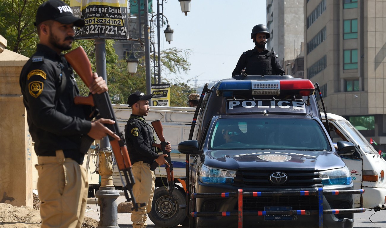 In this file photo, taken on February 8, 2024, policemen stand guard during Pakistan’s national elections in Karachi. (AFP/File)