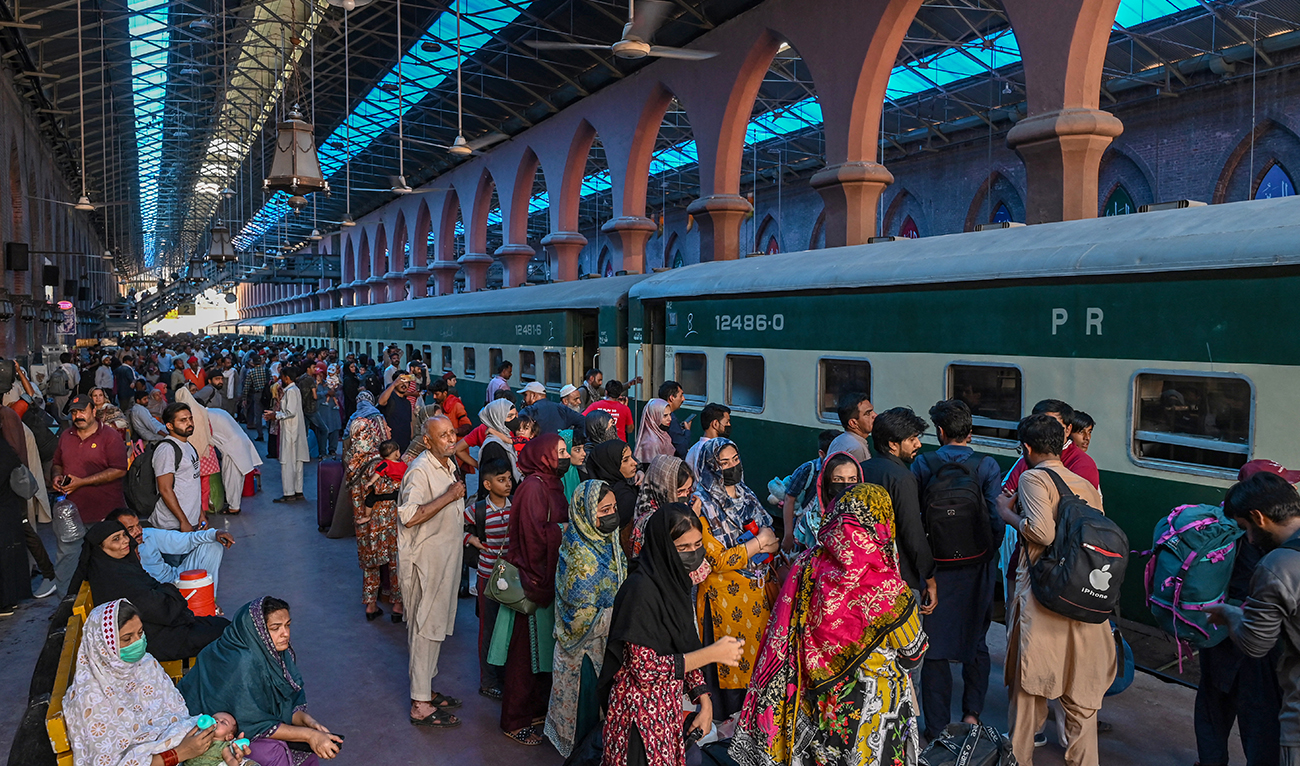 People wait to board a train at a railway station in Lahore on June 15, 2024, as they travel back home ahead of Eid al-Adha, the feast of the sacrifice marking the end of the Hajj pilgrimage to Mecca. (AFP/File)