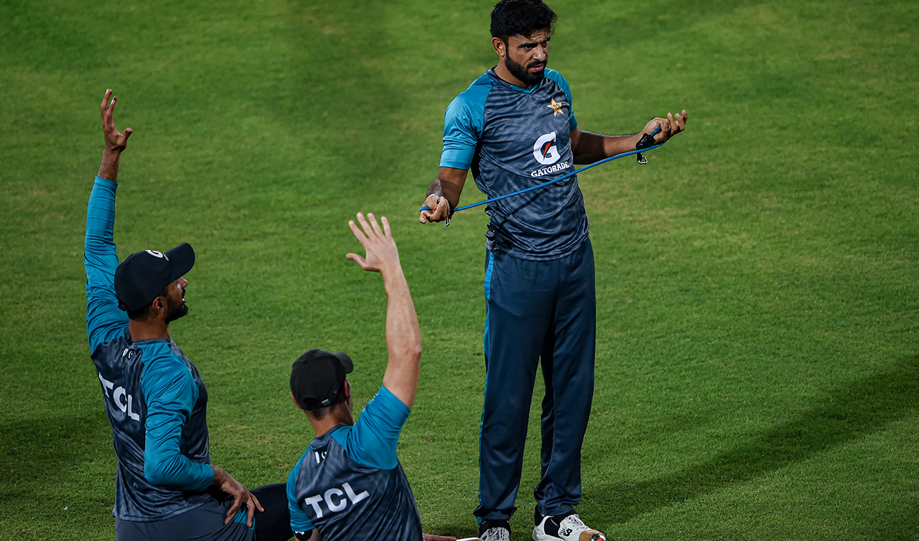 Pakistan's Aamer Jamal (R) and Shan Masood (L) warms up during a training session ahead of the fourth Twenty20 international cricket match against England at the National Cricket Stadium in Karachi on September 24, 2022. (AFP/File)