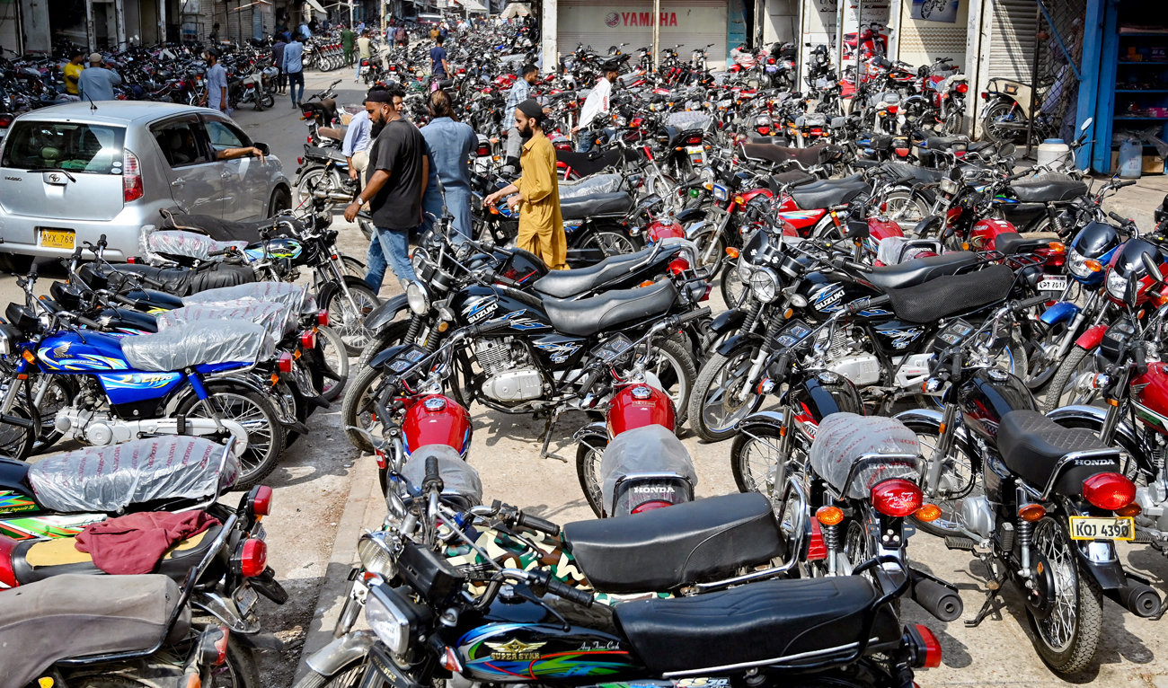 People visit motorcycle market in Karachi on June 26, 2024. (AFP)