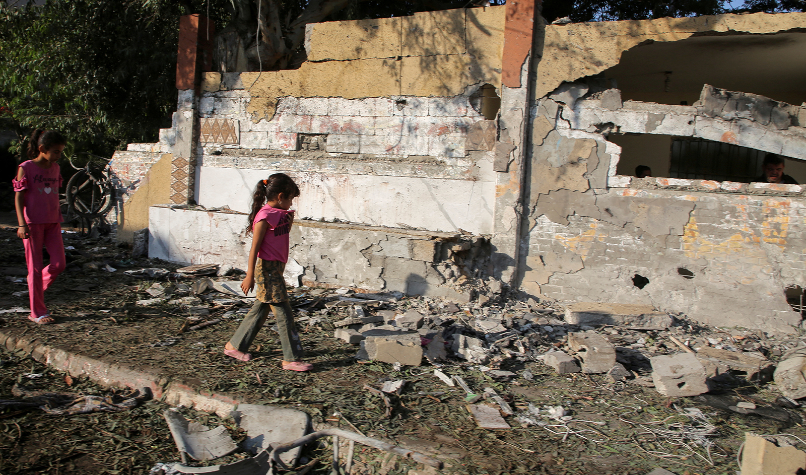 Palestinian girls walk at the site of an Israeli strike, outside a school sheltering displaced people, amid Israel-Hamas conflict, in Khan Younis in the southern Gaza Strip on July 10, 2024. (REUTERS)