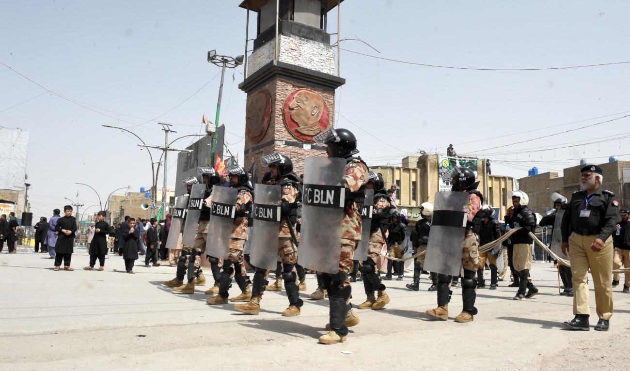 Security personnel stand guard during a procession of Shiite Muslims on the tenth day of Ashura in the Islamic month of Muharram, in Quetta on July 29, 2023. (AFP/File)_