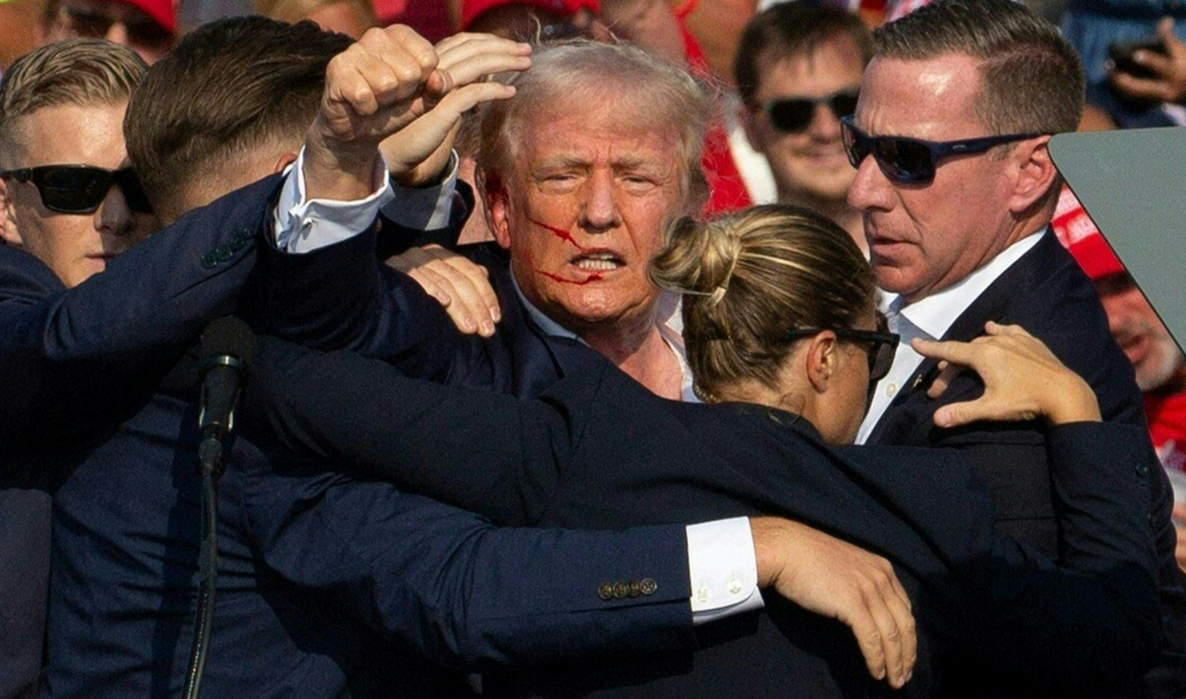 Republican candidate Donald Trump is seen with blood on his face surrounded by secret service agents as he is taken off the stage at a campaign event at Butler Farm Show Inc. in Butler, Pennsylvania, July 13, 2024. (AFP)