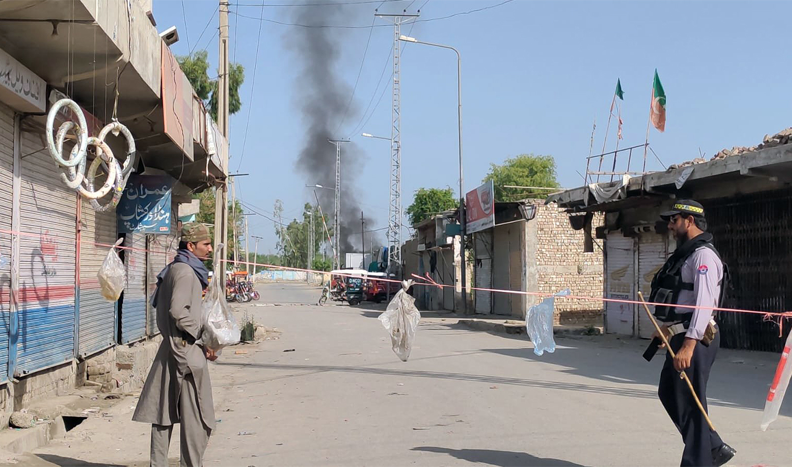 Policeman stands guard near a blast sight in Bannu, Pakistan on July 15, 2024. (@Saleem_wazir7/X)