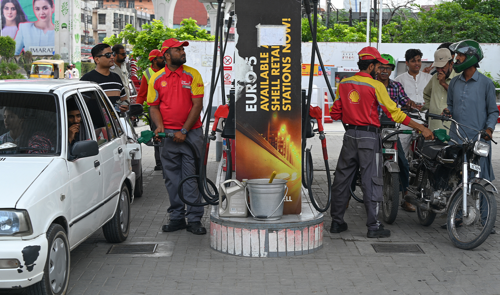 A worker pumps petrol in vehicles at a fuel station in Rawalpindi on July 16, 2023. (AFP/File)
