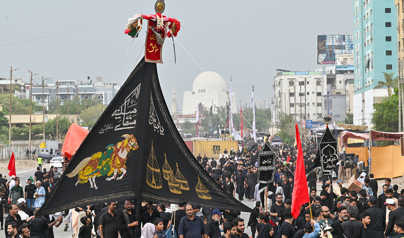 Shiite Muslims take part in a religious procession on the ninth day of the Islamic month of Muharram, in Karachi on July 16, 2024. (AFP)