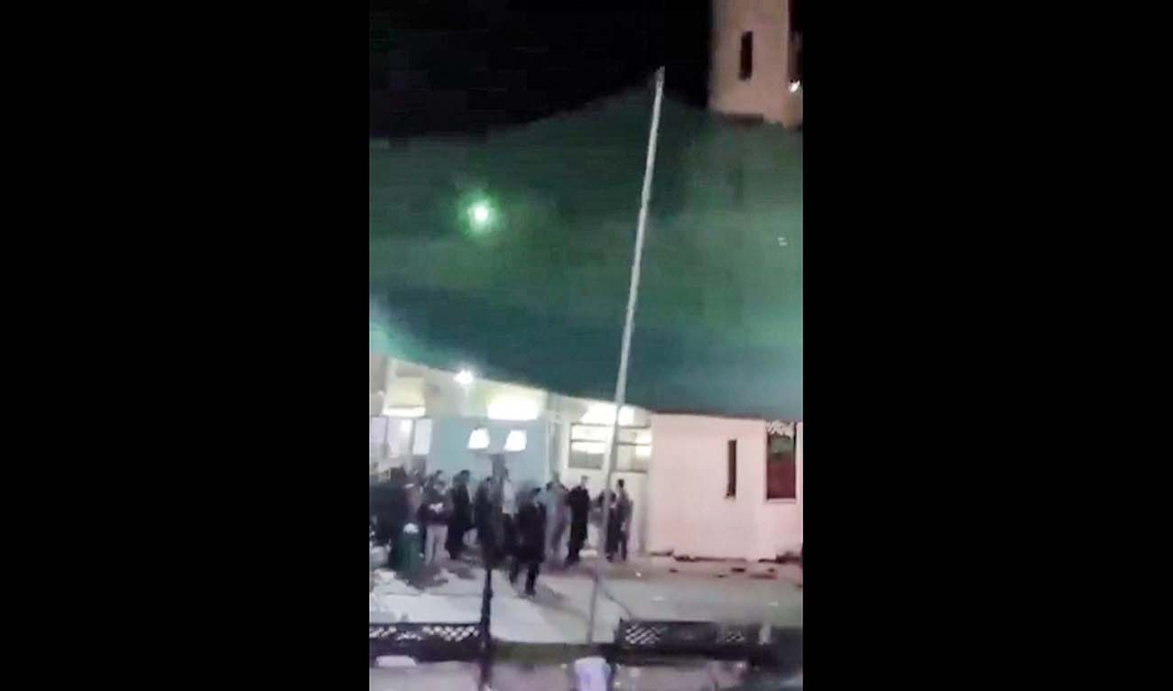 This image grab from a UGC video taken on July 16, 2024 shows shows people fleeing the scene of a shooting at the Imam Ali Mosque in the Al-Wadi Al-Kabir area in the east of Oman's capital Muscat. (AFP/File)