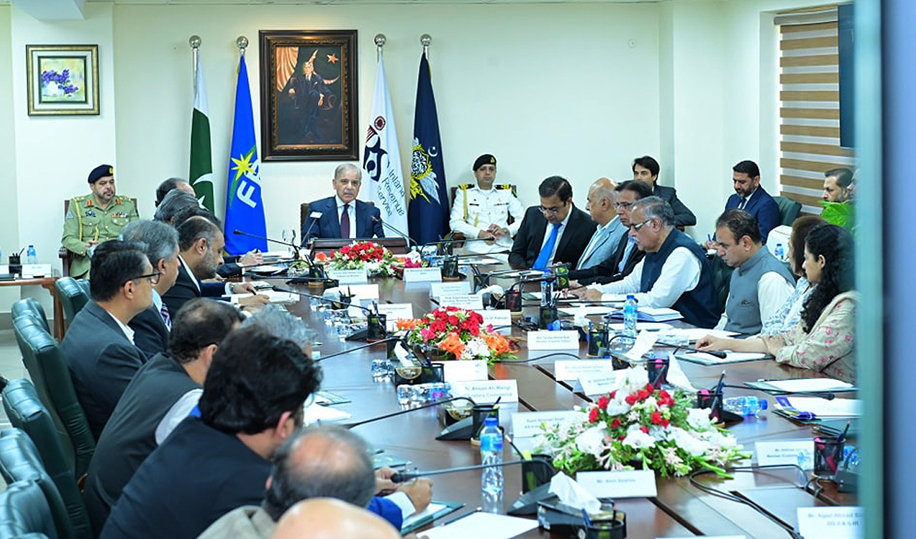 In this file photograph, taken and released by Prime Minister’s Office, Pakistan Prime Minister Shehbaz Sharif (center) speaks during his visit to the Federal Board of Revenue headquarters in Islamabad. (Photo courtesy: PMO/File)