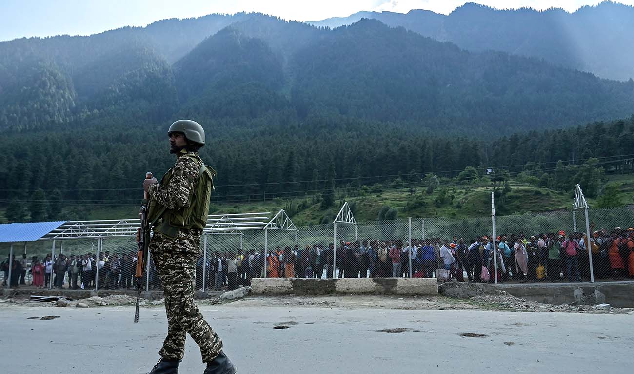 An Indian security personnel stands guard as Hindu pilgrims begin their pilgrimage to the cave shrine of Amarnath from a base camp in Pahalgam on June 28, 2024. (AFP/File)
