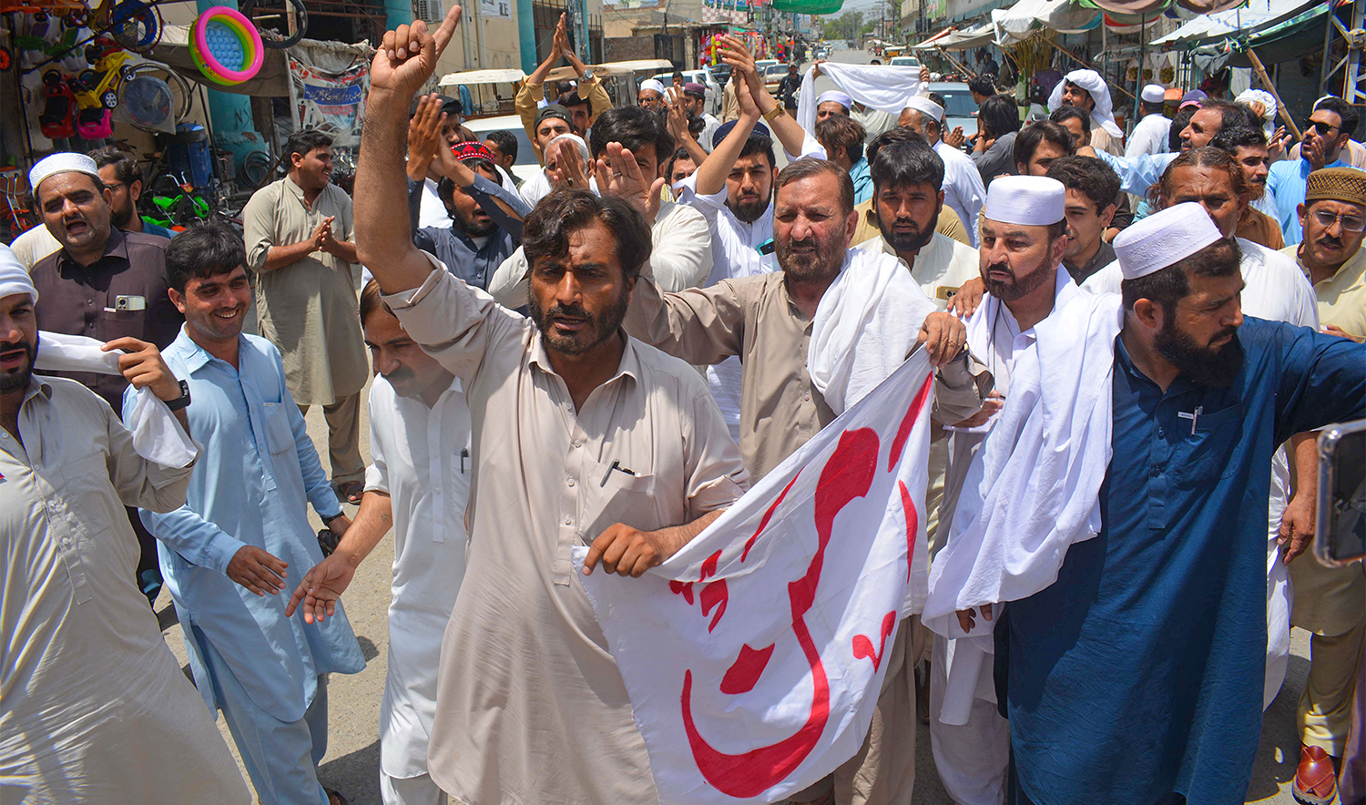 People protest for peace a day after the suicide attack by militants on an army enclave in Bannu, on July 16, 2024. (AFP)