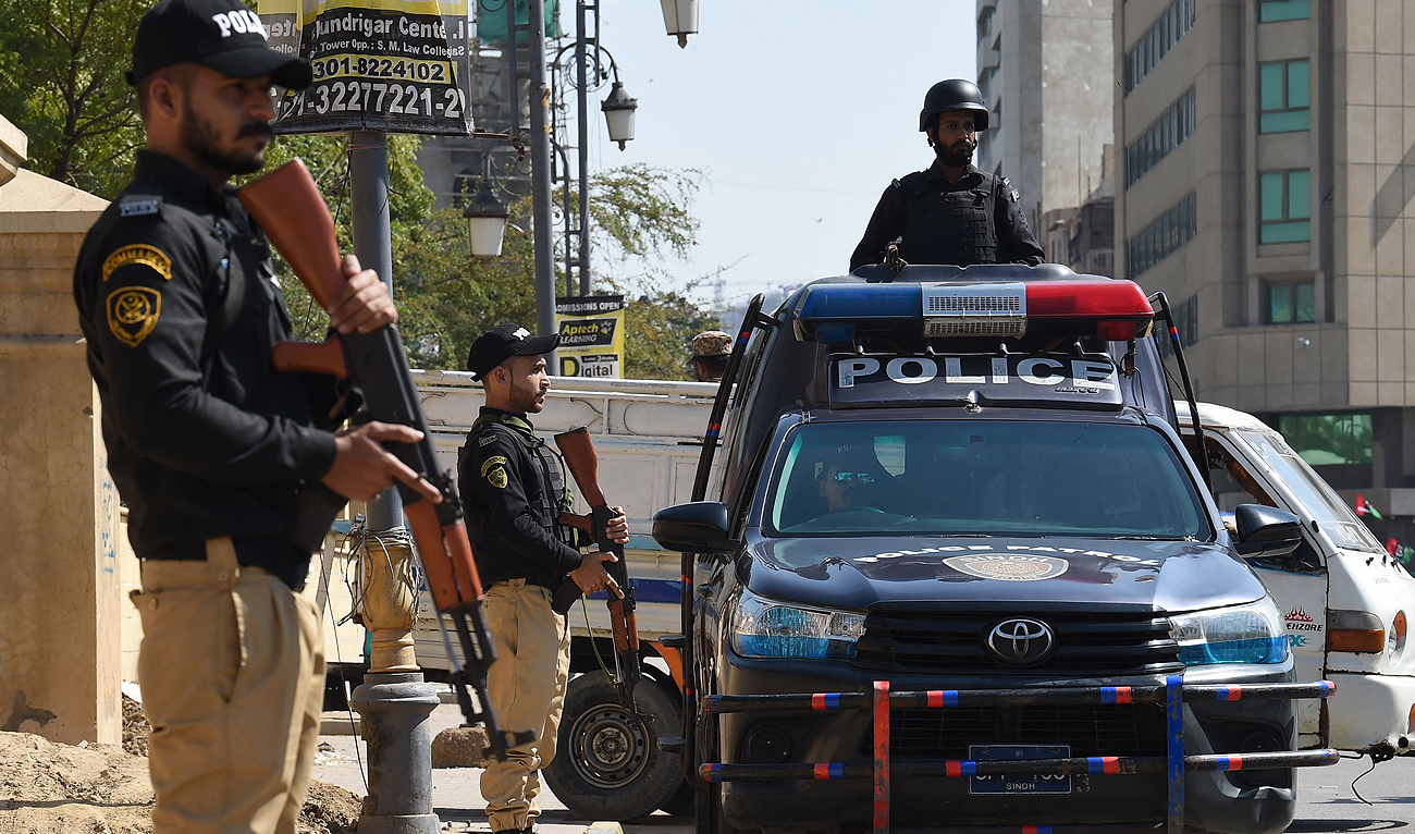 In this file photo, taken on February 8, 2024, policemen stand guard during Pakistan’s national elections in Karachi. (AFP/File)