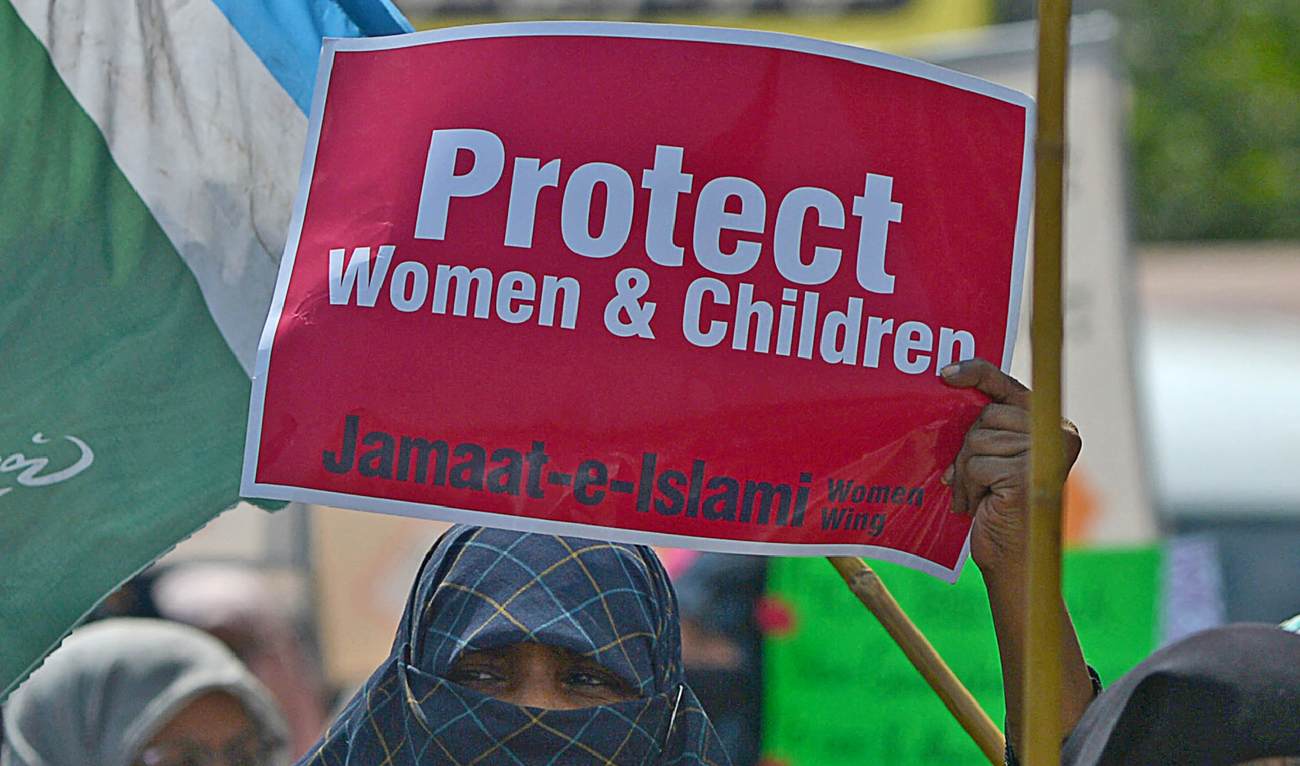 In this file photograph, taken on March 8, 2022, a woman activist holds a placard reading 'Protect Women and Children' during a rally to mark the International Women's Day in Karachi. (AFP/File)