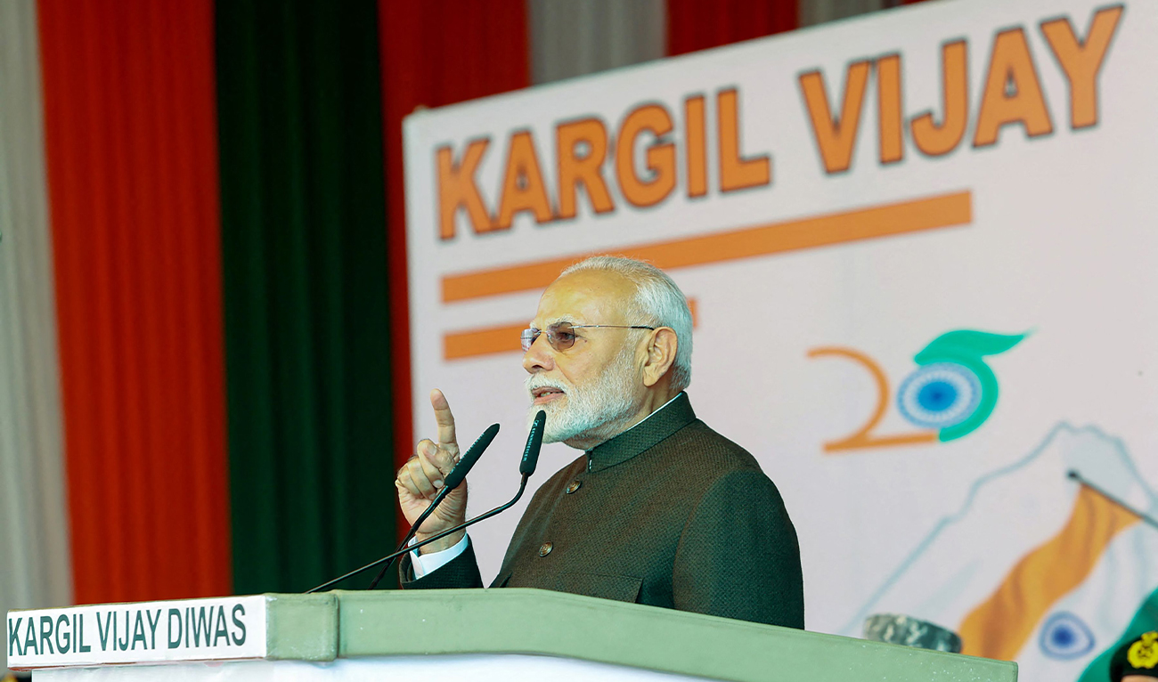 In this handout photograph taken and released on July 26, 2024 by the Indian Press Information Bureau (PIB), India's Prime Minister Narendra Modi speaks during a ceremony on the occasion of Kargil Vijay Diwas at Kargil War Memorial in Drass. (AFP/Indian Press Information Bureau)