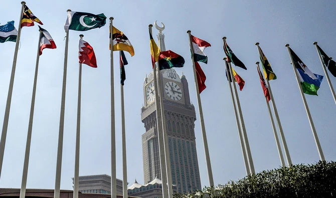 A picture taken on November 17, 2016 shows the national flags of the members of Organisation of Islamic Cooperation (OIC) states flying in front of the clock of the Abraj al-Bait Towers which overlooks the Grand Mosque in the holy city of Makkah. (AFP/File)
