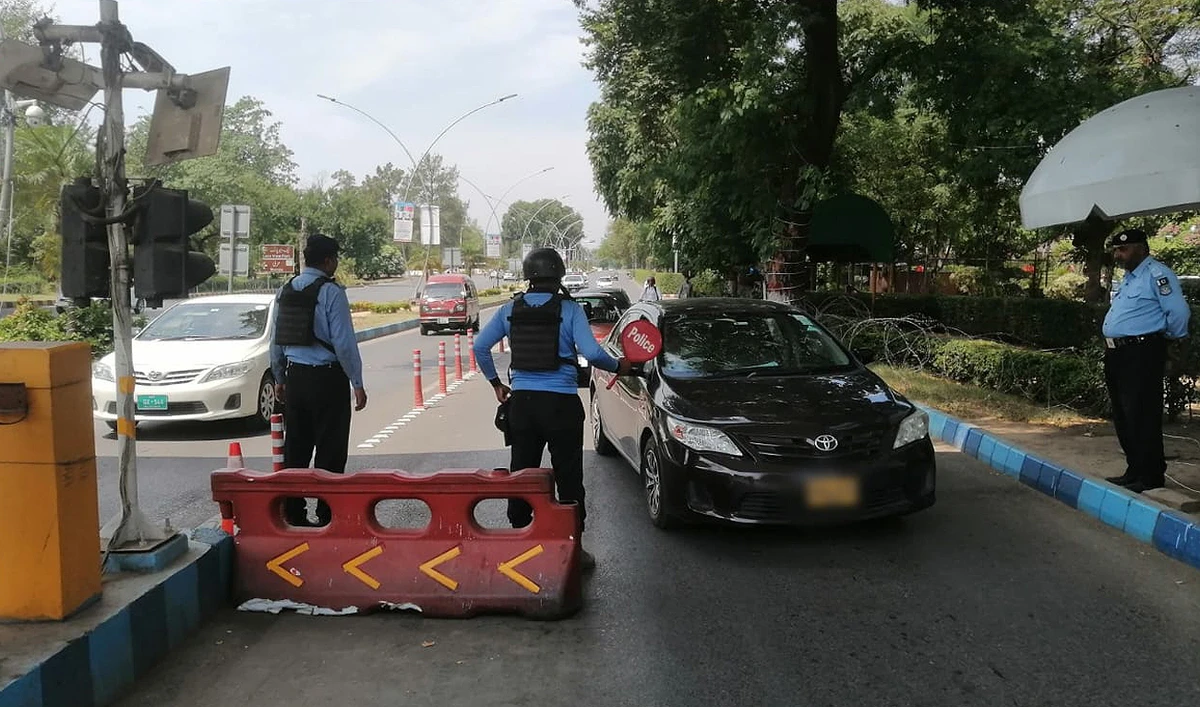 In this file photograph, taken and released by the Islamabad Police on June 21, 2024, security officials check vehicles entering the Red Zone of Pakistan’s federal capital. (Photo courtesy: Islamabad Police)