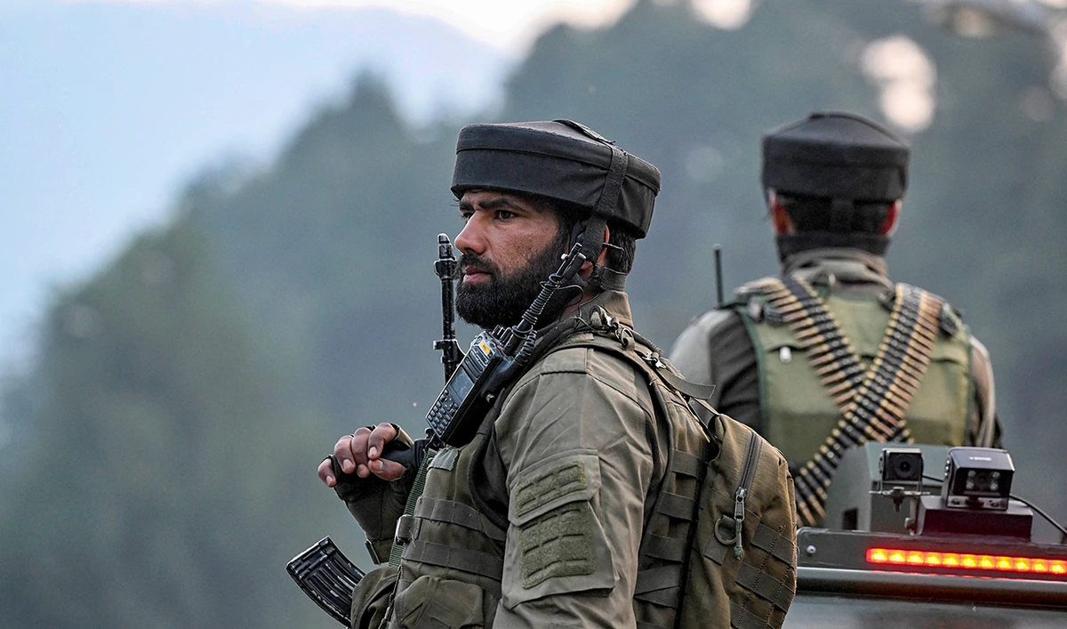 Security personnel stand guard as Hindu devotees begin their pilgrimage to the cave shrine of Amarnath from a base camp in Pahalgam on June 29, 2024. (AFP/File)